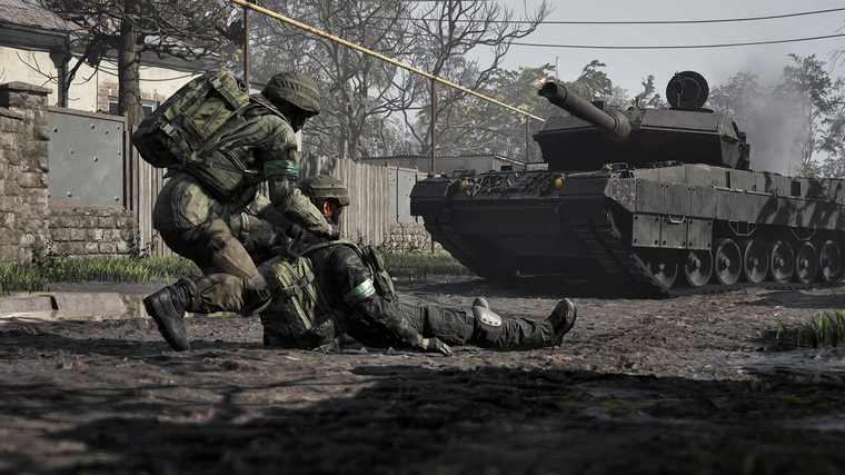 A soldier drags a downed teammate behind cover as a main battle tank rolls past a wall