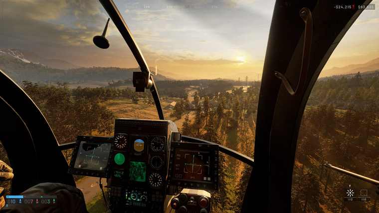 View from a helicopter cockpit with instrument panel lit, flying over hills at dawn