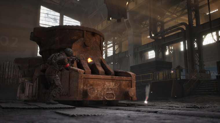 An armoured vehicle parked inside a derelict industrial hall